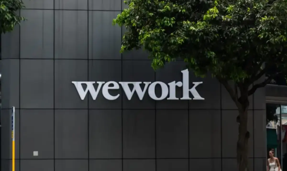 An office workspace scene evoking the corporate and financial backdrop of WeWork's IPO story